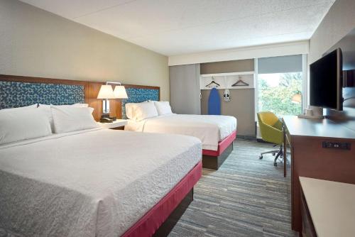 a hotel room with two beds and a flat screen tv at Hampton Inn by Hilton Harrisburg West in Mechanicsburg