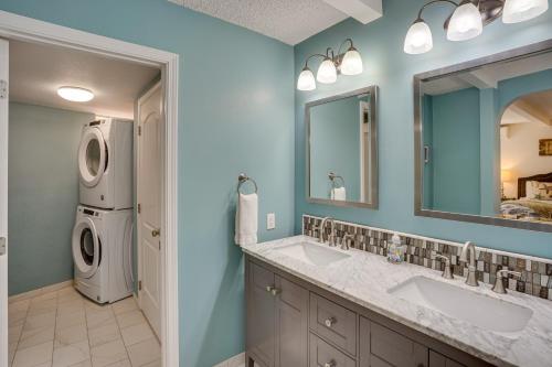 a bathroom with two sinks and a washer and dryer at Family-Friendly Avalon Penthouse with Ocean View! in Avalon