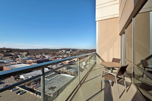 a balcony with a chair and a view of a city at Hilton Branson Convention Center in Branson