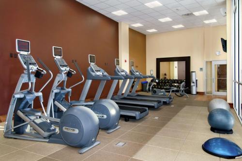 a gym with a row of treadmills and machines at Hilton Branson Convention Center in Branson