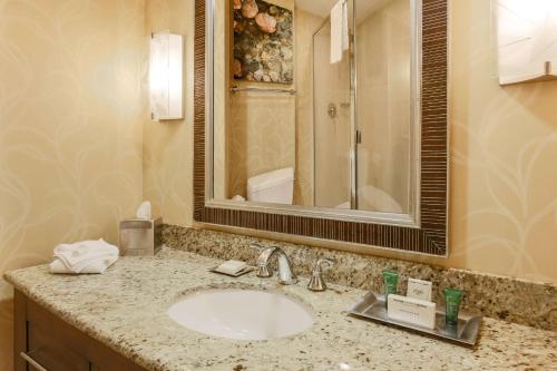 a bathroom with a sink and a mirror at Hilton Branson Convention Center in Branson