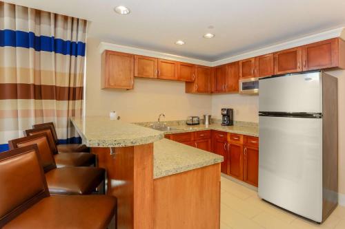 a kitchen with wooden cabinets and a white refrigerator at Hilton Branson Convention Center in Branson