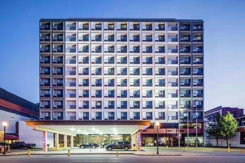 a large white building with a parking lot in front of it at DoubleTree by Hilton Huntington, WV in Huntington