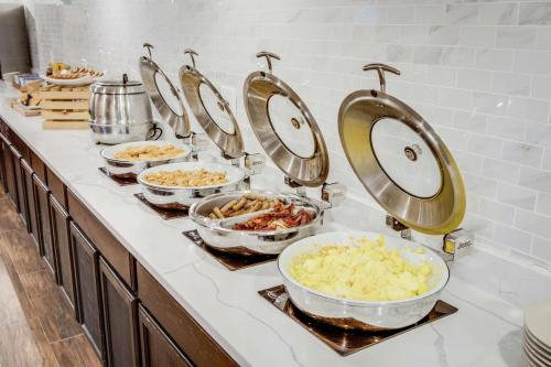 a buffet with bowls of food on a counter at DoubleTree by Hilton Huntington, WV in Huntington