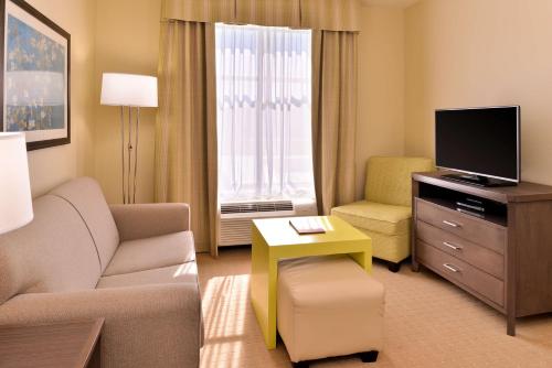 a living room with a couch and a tv at Homewood Suites by Hilton Houma in Houma