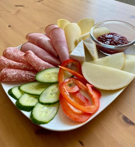 a plate of food with sausage and vegetables on a table at Eklinds Rum och Trädgård in Gothenburg