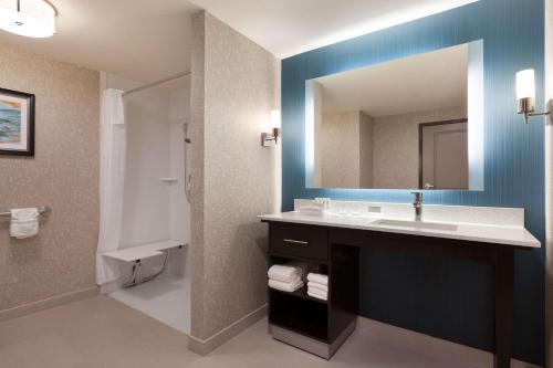 a bathroom with a sink and a mirror at Homewood Suites by Hilton North Houston/Spring in Spring