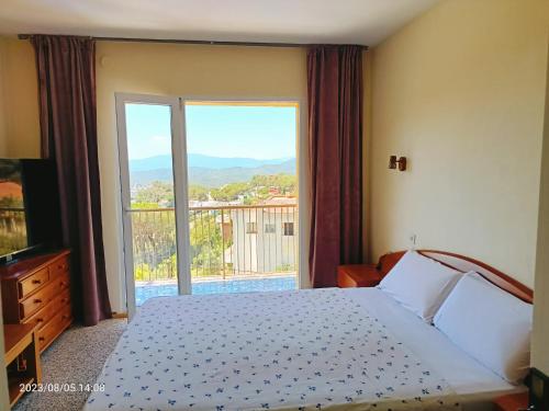 a bedroom with a bed and a large window at House Sabina in Lloret de Mar