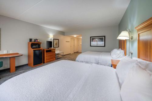 a hotel room with two beds and a kitchen at Hampton Inn Wilmington University Area in Wilmington