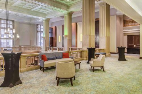 a lobby with a couch and chairs in a building at Hilton Garden Inn Indianapolis Downtown in Indianapolis