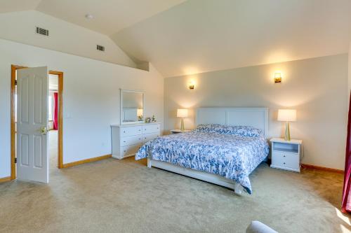a bedroom with a bed with a blue bedspread at Seaside Eureka Vacation Rental with Bay Views! in Eureka