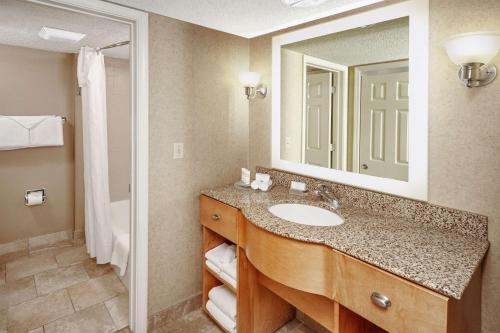 a bathroom with a sink and a mirror at Homewood Suites by Hilton Indianapolis At The Crossing in Indianapolis