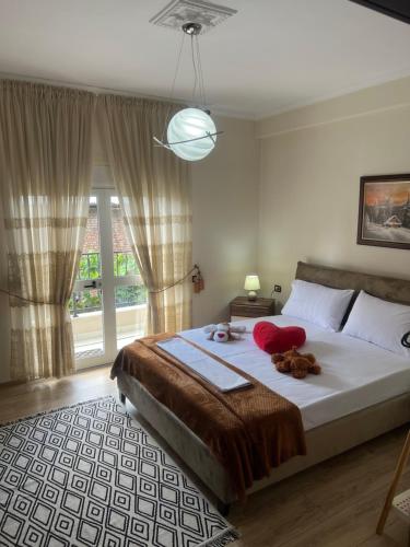 a bedroom with a large bed and a large window at Dream House Korça in Korçë