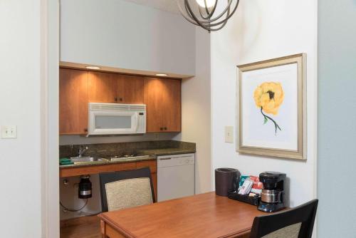 a kitchen with a table and a microwave at Homewood Suites by Hilton Indianapolis Airport / Plainfield in Plainfield