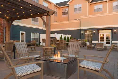 an outdoor patio with chairs and a fire pit at Homewood Suites by Hilton Indianapolis Airport / Plainfield in Plainfield