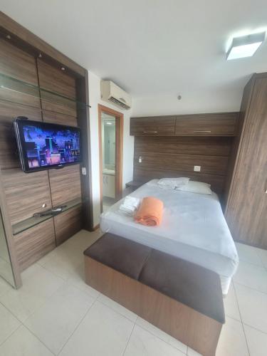 a bedroom with a bed and a flat screen tv at Saint Moritz Express vista Esplanada By Rei dos Flats in Brasilia