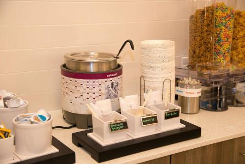 a kitchen counter with a counter top with food at Hampton Inn & Suites Jackson Coliseum in Jackson