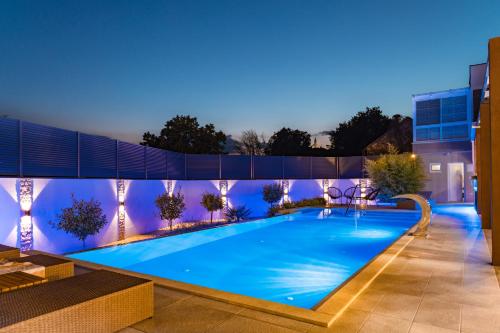 a swimming pool in the middle of a building at night at Holiday Home Korda in Čapljina