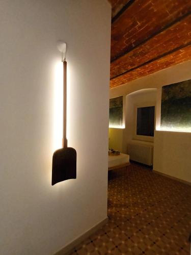 a light hanging on a wall in a room at AFFITTACAMERE SobborgoSpina47 in Sarzana