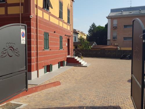 an empty street next to a red brick building at AFFITTACAMERE SobborgoSpina47 in Sarzana