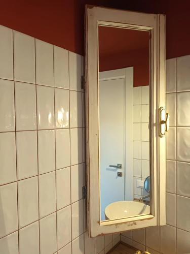 a bathroom with a mirror and a sink at AFFITTACAMERE SobborgoSpina47 in Sarzana