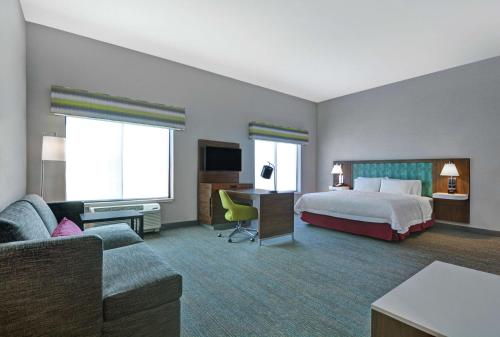 a hotel room with a bed and a couch at Hampton Inn & Suites Middleburg, Fl in Middleburg