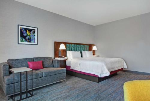 a hotel room with a bed and a couch at Hampton Inn & Suites Middleburg, Fl in Middleburg
