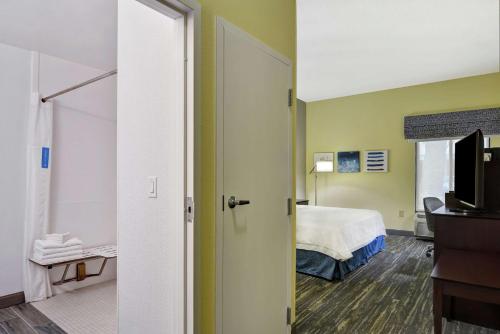 Habitación de hotel con cama y TV en Hampton Inn Jacksonville Ponte Vedra, en Jacksonville Beach