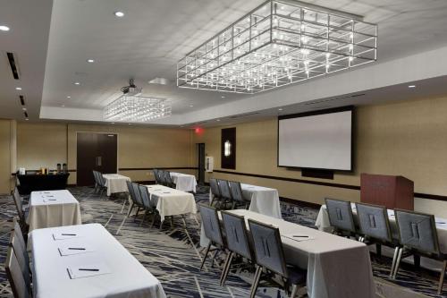 a conference room with tables and chairs and a screen at Doubletree By Hilton Jamestown, Ny in Jamestown