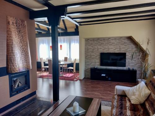 a living room with a couch and a fireplace at Ferienwohnung an der Murg in Baiersbronn