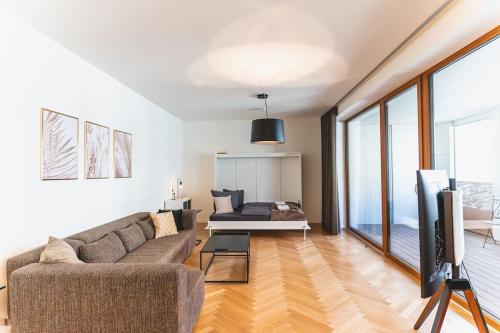 a living room with a couch and a bed at TIP! Design trifft Lage 120 qm Premium Apartment in Dresden