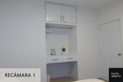 a white kitchen with white cabinets in a room at Apartamento nuevo en Veracruz Centro in Veracruz