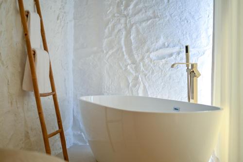 a white bath tub in a bathroom with a window at Villa Rosemary East in Makarska