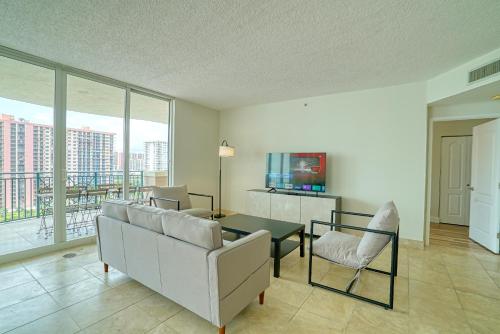 a living room with a couch and a table and chairs at The King David Condos in Miami Beach