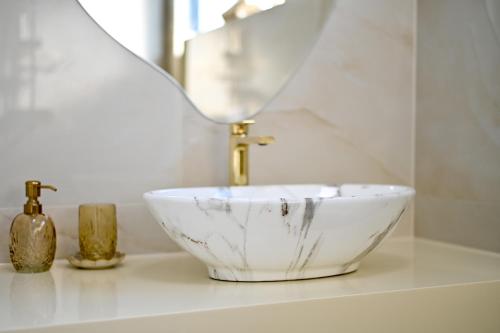 a bathroom with a bowl sink and a mirror at Villa Rosemary East in Makarska