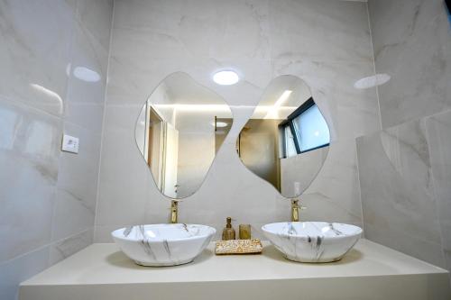 a bathroom with two sinks and a large mirror at Villa Rosemary East in Makarska