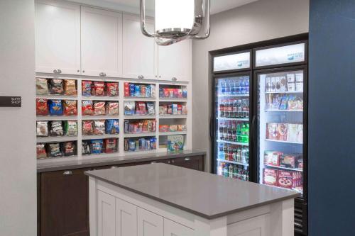 a kitchen with a counter and shelves of food at Homewood Suites By Hilton Las Vegas City Center in Las Vegas