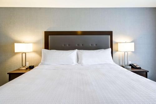 a large white bed with two lamps on two tables at Homewood Suites By Hilton Las Vegas City Center in Las Vegas