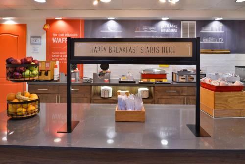 a sign for a happy breakfast starts here in a kitchen at Hampton Inn & Suites Las Vegas Airport in Las Vegas