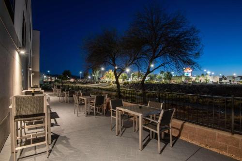 a row of tables and chairs on a patio at night at Hampton Inn & Suites Las Vegas-Henderson in Las Vegas