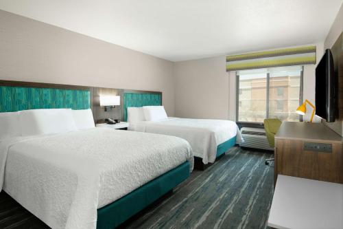 a hotel room with two beds and a television at Hampton Inn & Suites Las Vegas-Henderson in Las Vegas