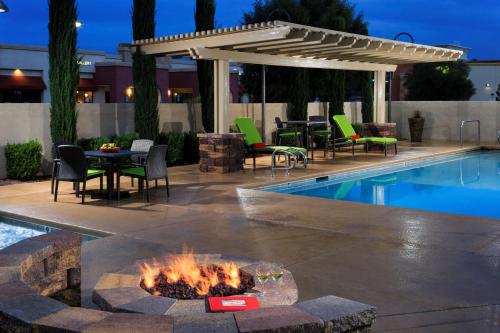 a patio with a fire pit next to a pool at Hampton Inn & Suites Las Vegas South in Las Vegas
