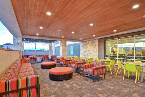 a restaurant with colorful chairs and tables and windows at Home2 Suites By Hilton Las Vegas Strip South in Las Vegas