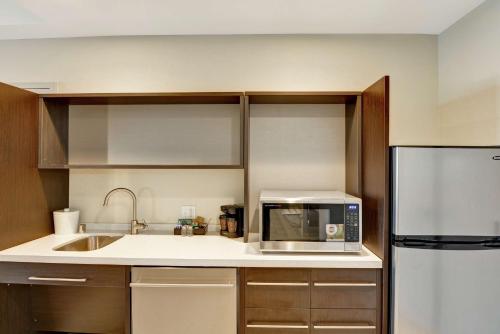 a kitchen with a sink and a microwave at Home2 Suites By Hilton Las Vegas Strip South in Las Vegas