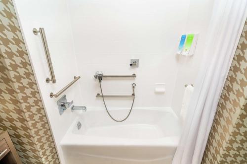 a bathroom with a shower with a sink at Home2 Suites by Hilton Las Vegas Stadium District in Las Vegas