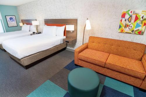 a hotel room with a bed and a couch at Home2 Suites by Hilton Las Vegas Stadium District in Las Vegas