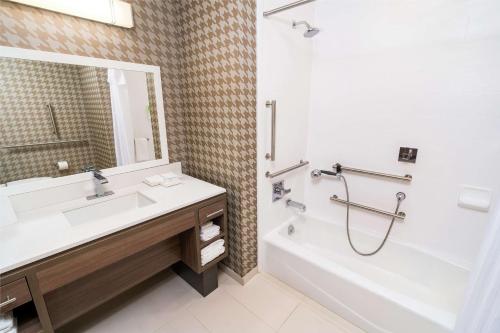 uma casa de banho com um lavatório, uma banheira e um chuveiro em Home2 Suites by Hilton Las Vegas Stadium District em Las Vegas