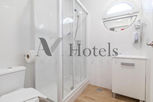 a white bathroom with a shower and a toilet at AYZ Joaquín Pol - Auto check-in property in Madrid