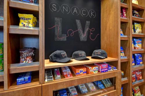 a shelf in a store with a chalkboard and some food at Home2 Suites by Hilton Las Vegas Convention Center - No Resort Fee in Las Vegas