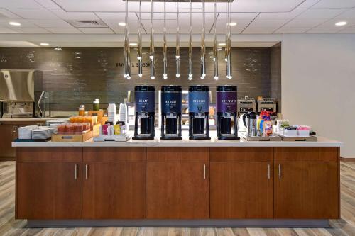 a bar with bottles of wine on a counter at Home2 Suites by Hilton Las Vegas Convention Center - No Resort Fee in Las Vegas